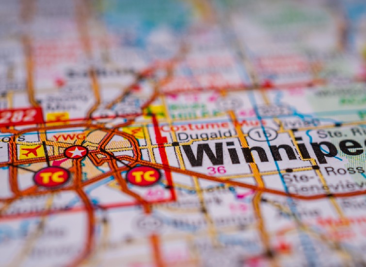 A detailed map close-up shows Winnipeg, highlighting nearby areas and landmarks with various icons such as an airport and transit routes, providing valuable context for the Manitoba Quarterly Market Overview.