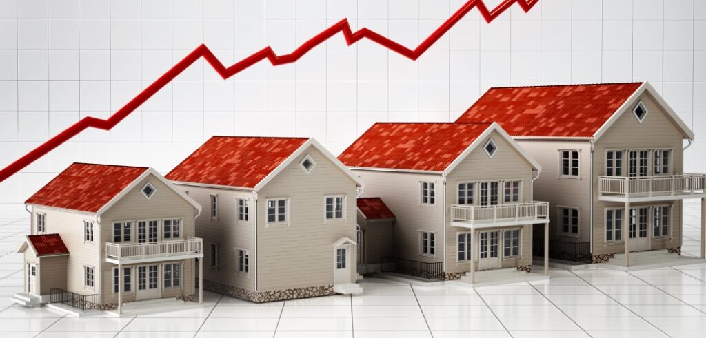 Four houses in a row with a red upward-pointing graph line in the background, indicating a rise in property values across Saskatchewan's housing market.